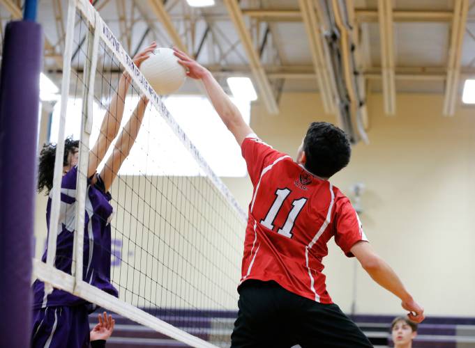 Athol’s Colin Mason (11) battles at the net against Holyoke’s YandielRiveraTroche (8) in the first set Friday in Holyoke.