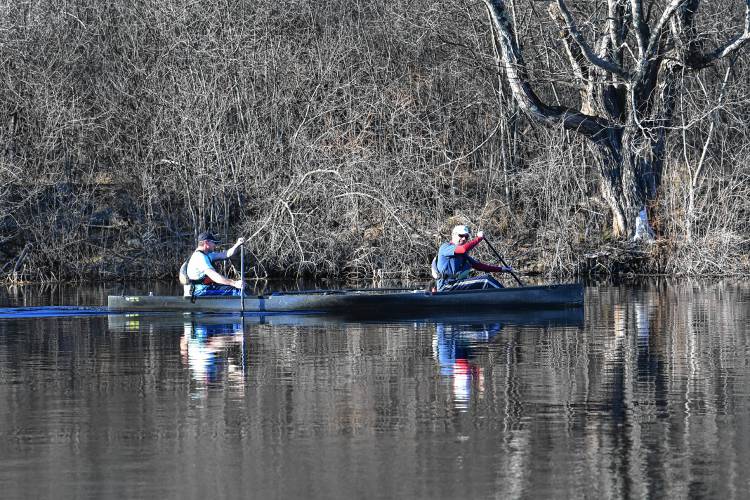 A pair of canoeists head upstream in a racing canoe on the Millers River in Orange. 