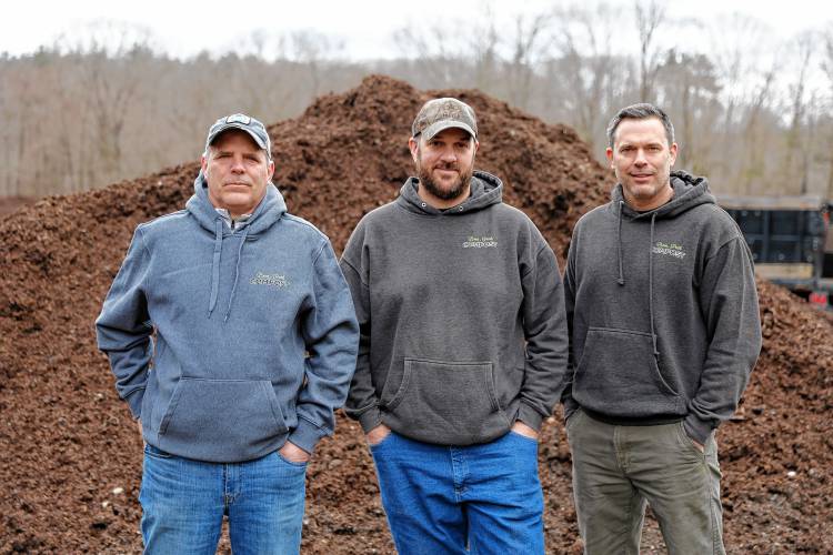Bear Path Compost owners Peter Melnik, from left, Mike Mahar and Mark Melnik on Saturday morning in Whately.