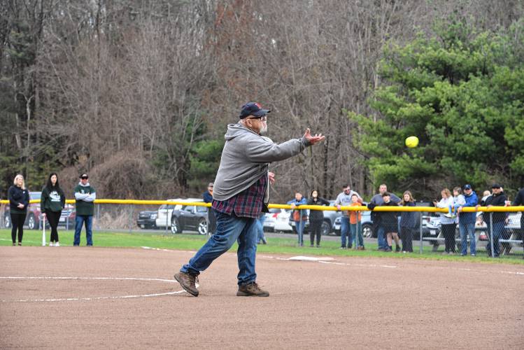 Bob Greene throws out the first pitch during the Opening Day ceremony of the Greenfield Girls Softball League at Murphy Park Saturday. 