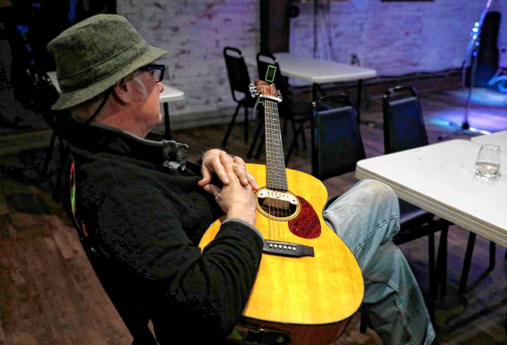 Florence local Tommy Twilite listens to a performance as he waits to take the stage during a recent open mic night at JJ’s Tavern in Florence.