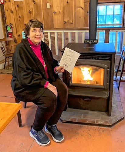 Cynthia Crosson holds a signature chart at the Country Store in Petersham. She will conduct a four-week course in handwriting analysis at the Athol Library, beginning on March 18.