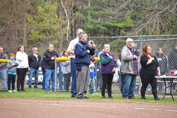 Umpire Rick Grant sings the national anthem during the Greenfield Girls Softball League’s Opening Day ceremony at Murphy Park on Saturday.  
