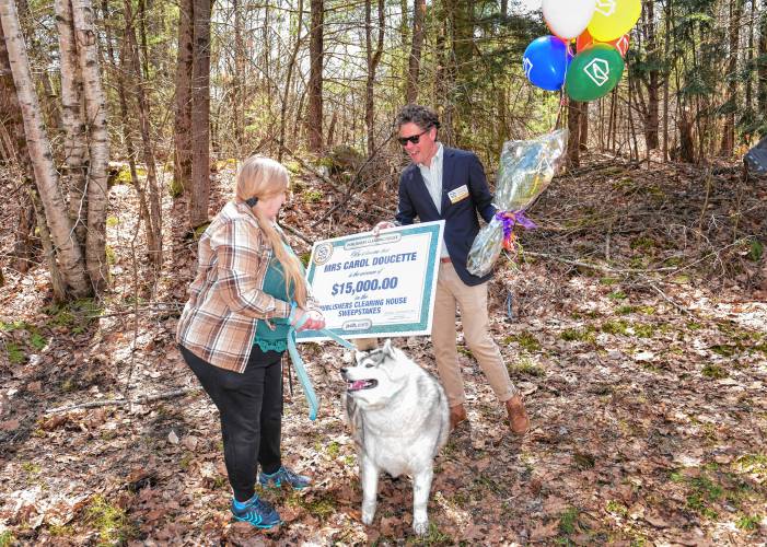 Carol Doucette of Royalston was surprised by Howie Guja of Publishers Clearing House Sweepstakes with news that she was a winner as she was walking her dog Rebel down her driveway.