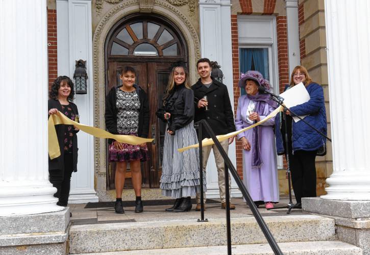 LEFT: A ribbon-cutting ceremony was held on Monday for the Revival Wheeler Mansion in Orange that owner Cynthia Butler has been restoring. From left are Missy Eaton of the North Quabbin Chamber of Commerce, Butler’s daughter Makayla Butler, Butler with scissors, her son Zachary Preston, Rose Marie Thoms of Rose Cottage Bed & Breakfast and state Rep. Susannah Whipps, I-Athol.RIGHT: Revival Wheeler Mansion owner Cynthia Butler talks with visitors during an open house on April 1.