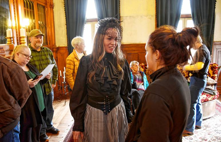 Revival Wheeler Mansion owner Cynthia Butler talks with visitors during an open house on April 1.