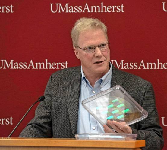 James J. Watkins, a professor in the department of Polymer Science and Engineering at UMass, holds an example of the kind of advanced optics imagining funded by a $5 million grant.