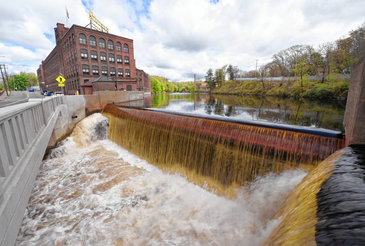 The tea-colored Millers River pours over the dam at Crescent Street in Athol near precision tool manufacturer L.S. Starrett.