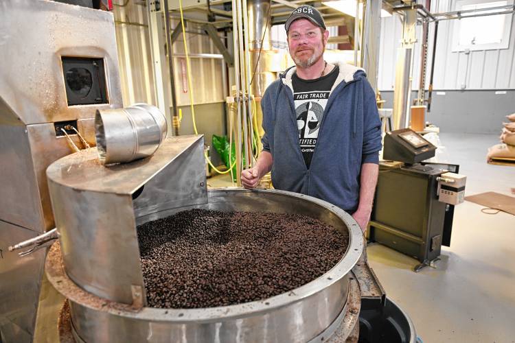 Darren Pierce with the coffee roaster at Fogbuster Coffee Works in Greenfield.