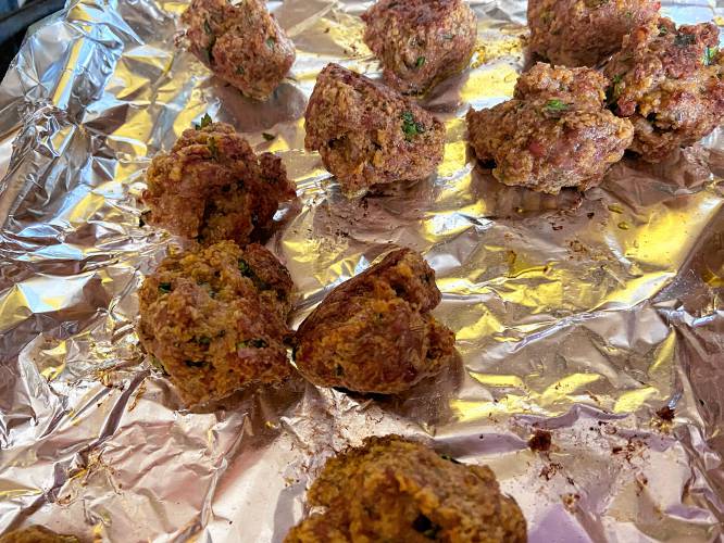 Lisa Ann Walter usually adds the cooked meatballs to her sauce and simmers the combination for an hour or so longer. I expected vegetarians so I kept most of the sauce separate, just adding a little of it to the meatballs as I reheated them before serving.