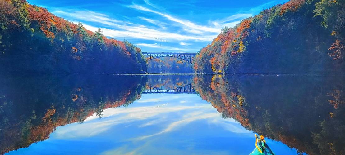 As you paddle downstream from Northfield to Barton Cove, the French King Bridge looms dramatically ahead, casting its reflection onto the channel. On your left after the bridge, you’ll see a slim rocky point where the Millers River joins the Connecticut.