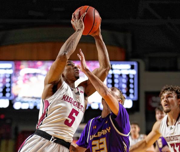 UMass’ Keon Thompson (5) goes to the basket against Albany during the Minutemen’s victory on Tuesday night at the Mullins Center in Amherst.