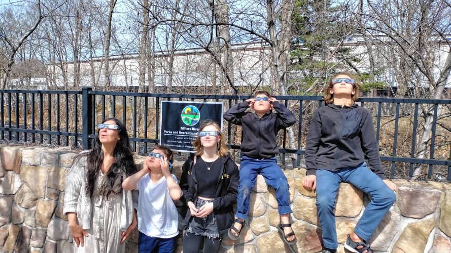 The Bullocks of Athol viewed Monday's eclipse using glasses provided by Athol Public Library. (From left) Jessica, Job, Ivey, Lucien and Octavian.
