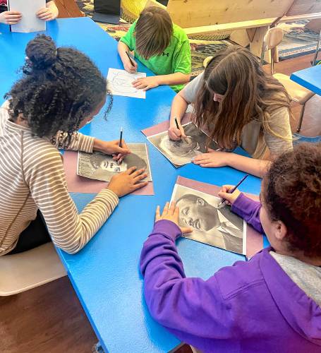 Students at The Village School in Royalston work on their pictures for a Black History Month project on historical figures they admire for their promotion of human understanding.