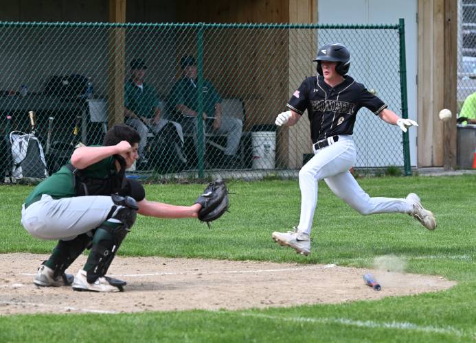 Pioneer’s Jackson Campbell scores as the throw to Greenfield catcher Luca Siano hits the bat on the ground earlier this season in Greenfield. 
