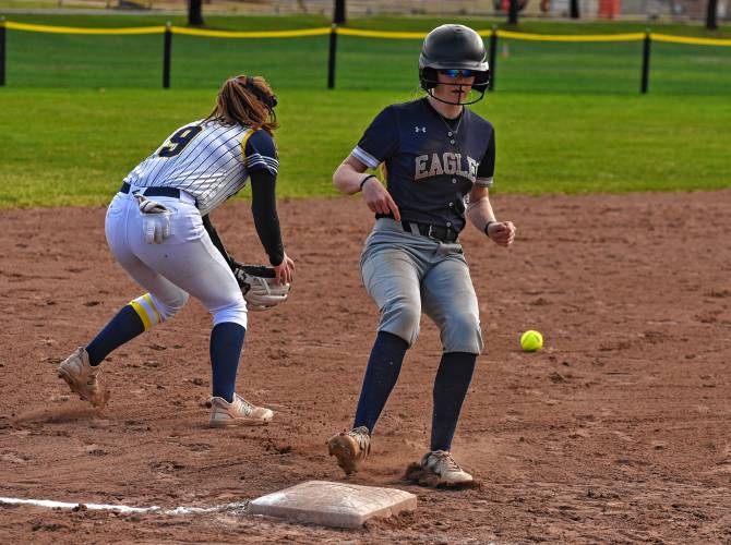 Franklin Tech’s Kaitlin Trudeau cruises into third base ahead of the throw while Hopkins Academy’s Cassidi Mushenski (9) prepares to field the ball on Friday in Turners Falls.