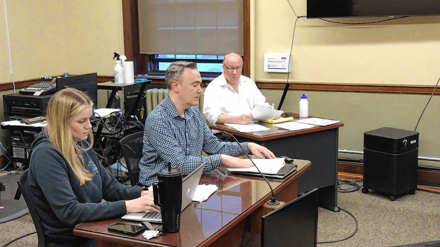 Ben Murphy (center), vice president of real estate for MassDevelopment, speaks with the Economic Development & Industrical Corporation to review an updated market study from Pinnacle Advisory Group relative to a proposed hotel in Athol.