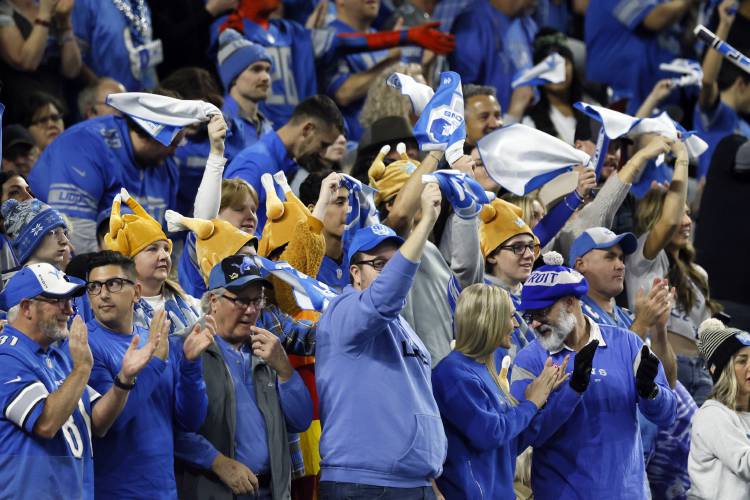 Detroit Lions fans cheer during the first half of an NFL football game against the Green Bay Packers, Thursday, Nov. 23, 2023, in Detroit. (AP Photo/Duane Burleson)