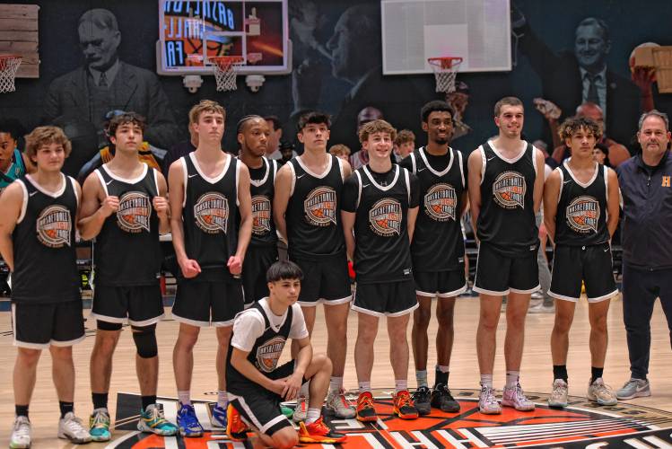 Team Black poses for a picture at Center Court of the Naismith Memorial Basketball Hall of Fame following the Class C and D Senior All-Star Game on Thursday night in Springfield.