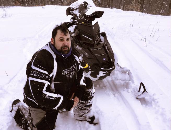  Jeffrey Smith poses with a snowmobile during March 2018, in Windsor, Mass. 