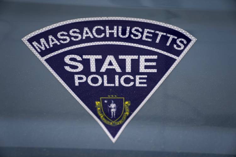 The seal of the commonwealth of Massachusetts is displayed on a Massachusetts State Police cruiser parked outside the Statehouse, March 3, 2023, in Boston. 