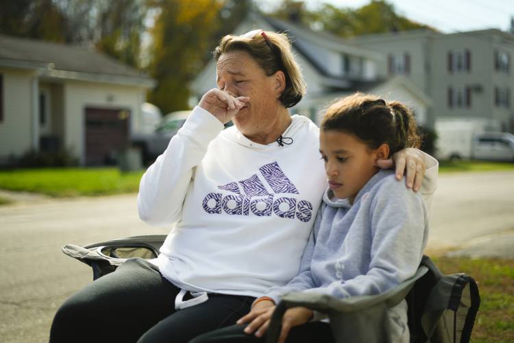 RETRANMISSION TO CORRECT LOCATION - Tammy Asselin, who was at Just-in-Time Recreation bowling alley with her daughter, Toni, during the recent mass shooting, wipes her face during an interview in Lewiston, Maine, Friday, Oct. 27, 2023. (AP Photo/Matt Rourke)