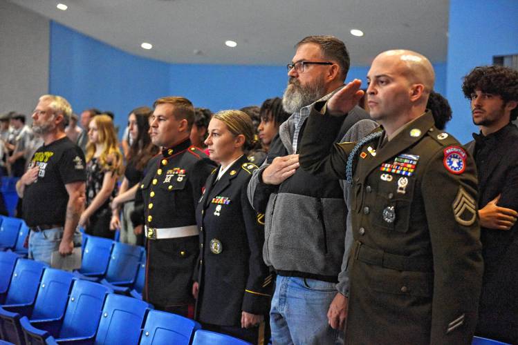 Local veterans stand during the singing of the national anthem during an assembly at Ralph C. Mahar Regional School in Orange on Thursday.