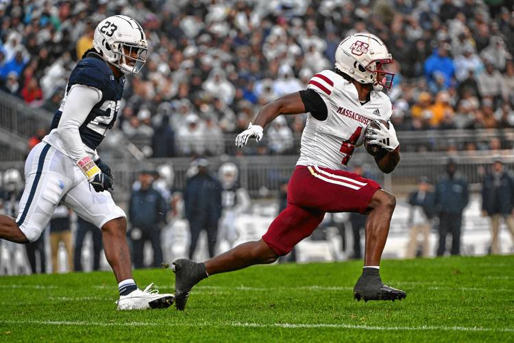 Massachusetts wide receiver George Johnson III (4) runs away from Penn State linebacker Curtis Jacobs (23) during action on Oct. 14 in State College, Pa.