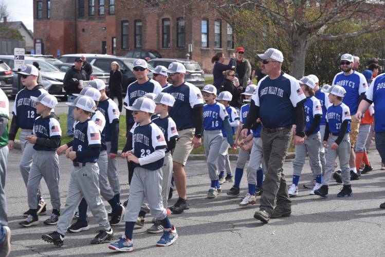 Greenfield Minor League baseball players make their way to Lunt Field during its Opening Day parade Sunday.