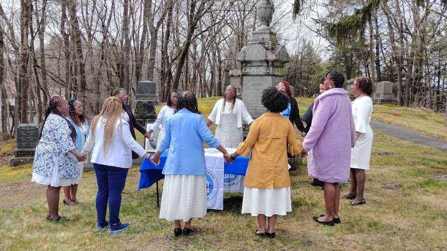 Spelman College alumnae sing the “Spelman Hymn” at the resting place of college founders Harriet B. Packard and Harriet E. Giles as part of the Founders Day celebration held on Saturday, April 20.