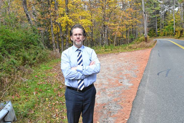 First Assistant District Attorney Steven Gagne stands in a small pull-off on Route 78 in Warwick, where a woman’s dismembered body was found in 1989.