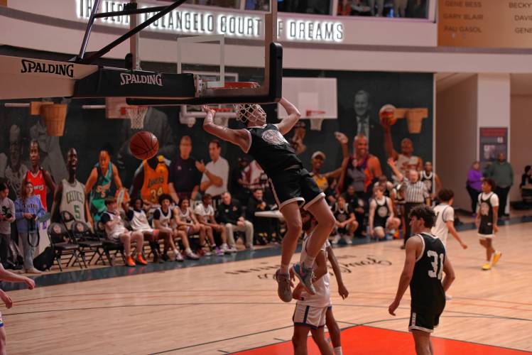 Northampton’s Silas Coles hangs from the rim following an emphatic two-handed jam during the Naismith Memorial Basketball Hall of Fame Western Mass. Class A and B Senior All-Star Game on Thursday night in Springfield.