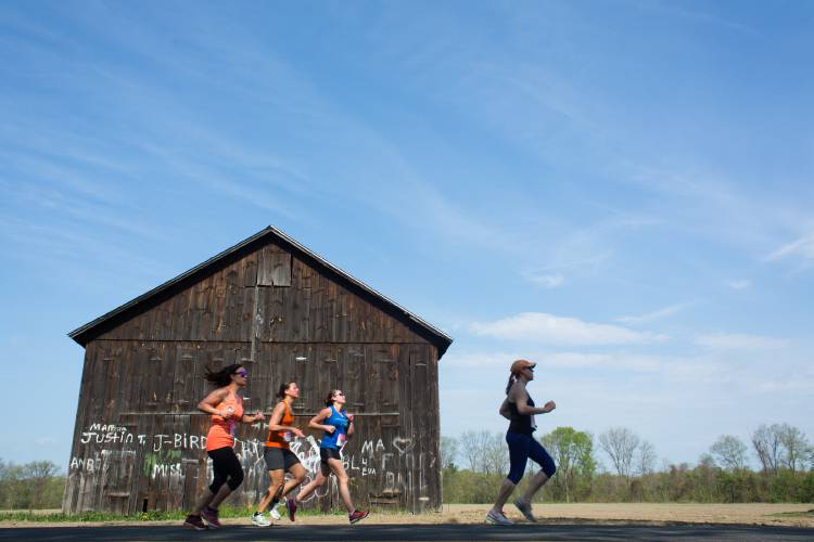 Participants in a past Mother's Day Half Marathon run down River Road in Hatfield. Participants in a past Mother's Day Half Marathon run down River Road in Hatfield.