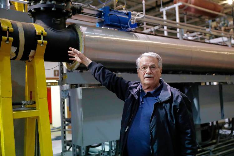 Michael Garjian explains the processes of his patented CarbonStar Catalytic Vacuum Pyrolysis System on Tuesday afternoon in Holyoke. The CarbonStar process converts any form of biomass into biochar using a catalytic vacuum pyrolysis in which temperature, residence time, and vacuum levels are precisely controlled by computer.