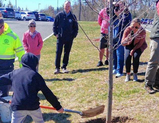 Fourth-graders from the class of teacher Ben Ledgard shovel dirt around the red maple sapling planted at Athol Community Elementary School in honor of Arbor Day.