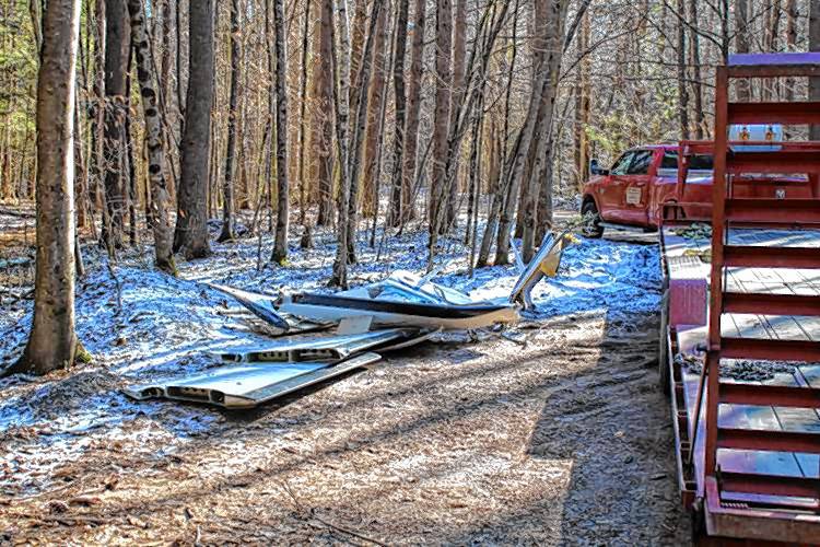 Investigators returned to Oak Hill Road in Greenfield Monday to collect debris and continue investigating a plane crash that killed all three on board Sunday morning in the Leyden Wildlife Management Area.