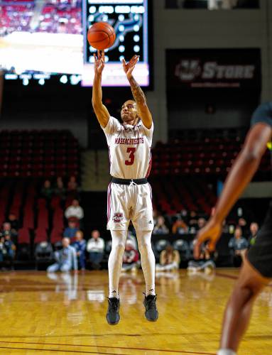 UMass guard Rahsool Diggins (3) hits a three-pointer against South Florida last weekend at the Mullins Center in Amherst.