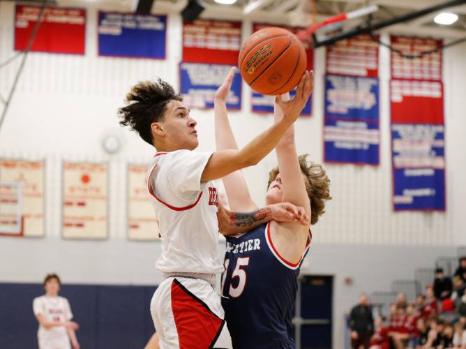 Athol’s Angel Castillo (5) drives to the hoop defended by Frontier’s Alexander Ellis (15) in the second quarter Thursday at Goodnow Gymnasium in South Deerfield.