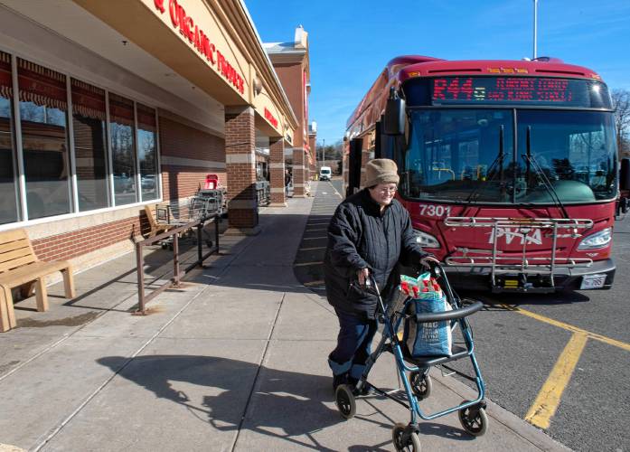 Laura Oldham of Northampton gets off the bus to get her shopping done at the Big Y store in Northampton. Oldham counts on public transportation to do her shopping. 