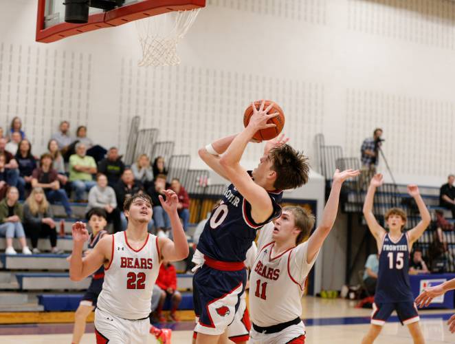 Frontier’s Max Millette (10) puts up a shot over Athol defenders Ray Castine (22) and Colby Goodwin (11) in the fourth quarter Thursday at Goodnow Gymnasium in South Deerfield.