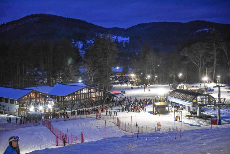 Racers queue up to take the detachable lift to the top during an evening high school ski meet at Berkshire East Mountain Resort.