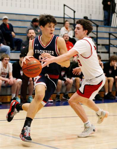 Frontier’s Luke Howard (21), left, drives the ball defended by Athol’s Ethan Bacigalupo (3) in the first quarter Thursday at Goodnow Gymnasium in South Deerfield.