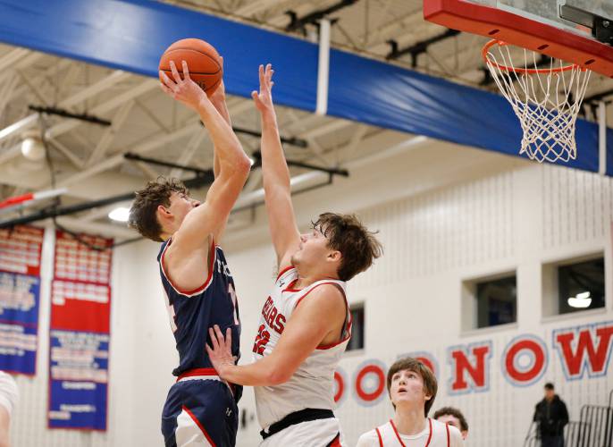 Frontier’s Owen Babb (14) puts up a shot over Athol defender Ray Castine (22) in the third quarter Thursday at Goodnow Gymnasium in South Deerfield.