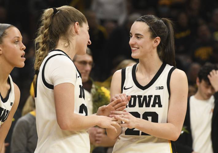Iowa guard Kate Martin, second from left, greets Iowa guard Caitlin Clark (22) after they were introduced during Senior Day ceremonies following their victory over Ohio State on March 3 in Iowa City, Iowa.