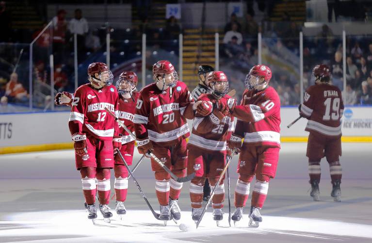 UMass players celebrate after a goal by Liam Gorman (20) against Denver in the second period of the opening round of the NCAA tournament Friday at the MassMutual Center in Springfield.
