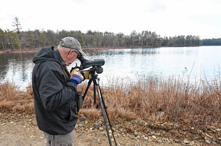 Athol resident Jeff Johnstone uses a spotting scope while bird watching at Lake Rohunta on Tuesday.