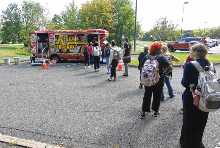 Students line up in the parking lot of Greenfield Community College on Wednesday for free ice cream from Ice Cream Emergency celebrating increased enrollment at GCC. 