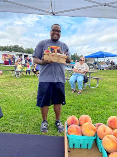 Justin Malone, whose Peach Caramel Crumble Pie won first prize in the annual Apex Orchards Peach Fest recipe contest, with his basket of goodies.