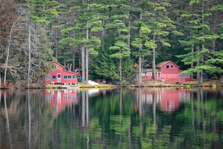 A pair of red cabins reflected in Lake Mattawa in Orange recently.