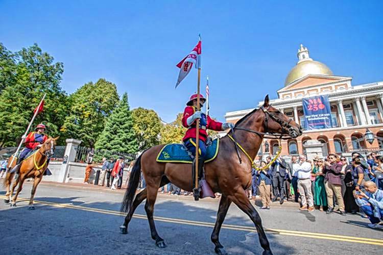 Members of the National Lancers state militia unit pass the front of the State House on Tuesday ahead of a press conference launching the MA250 initiative to promote the state during the upcoming Revolutionary War anniversary. Members of the National Lancers state militia unit pass the front of the State House on Tuesday ahead of a press conference launching the MA250 initiative to promote the state during the upcoming Revolutionary War anniversary.